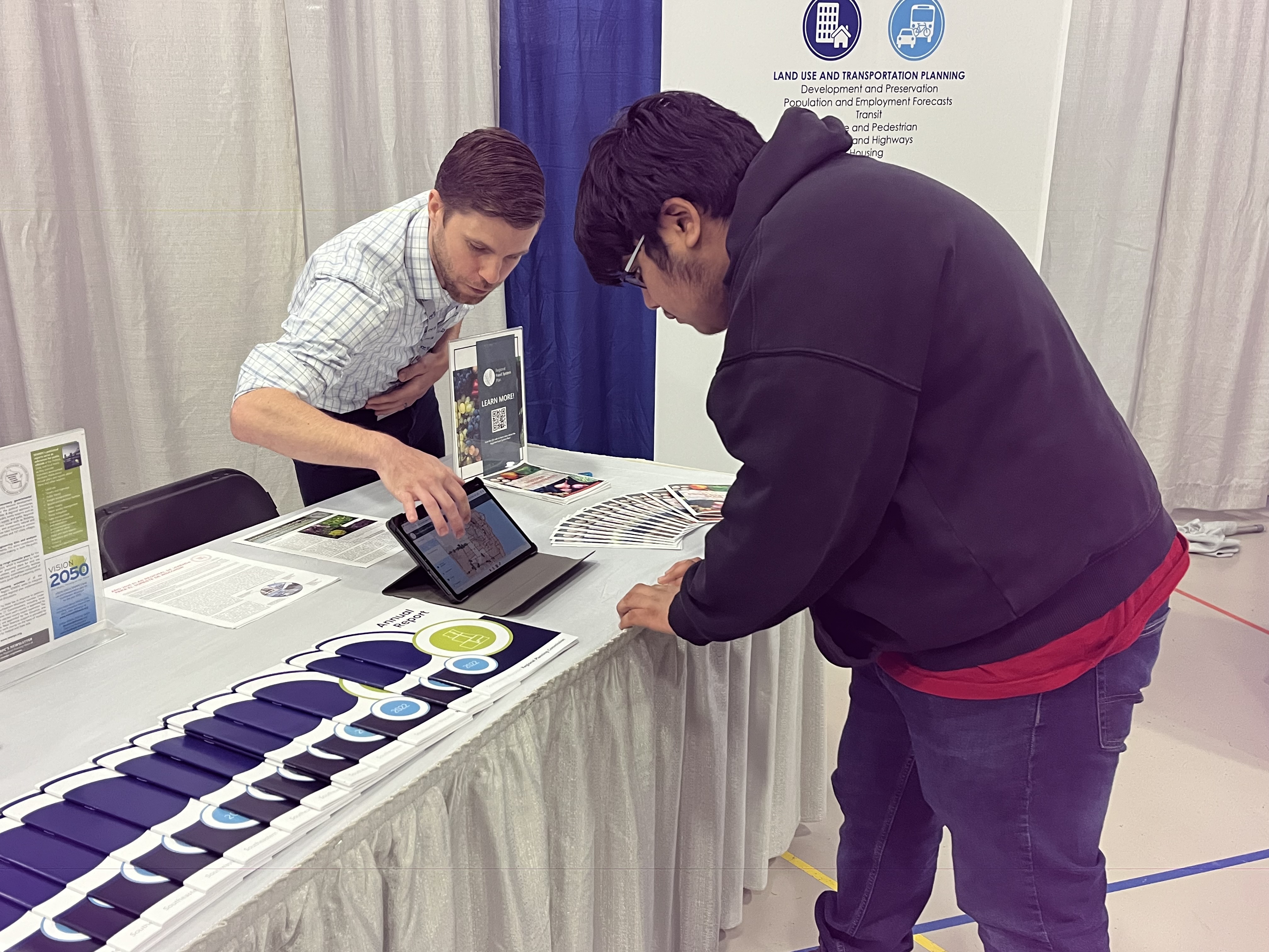 Commission staff person working with a student at an event